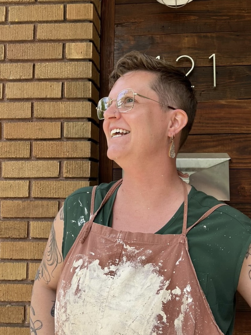 person in messy apron looking toward sky
